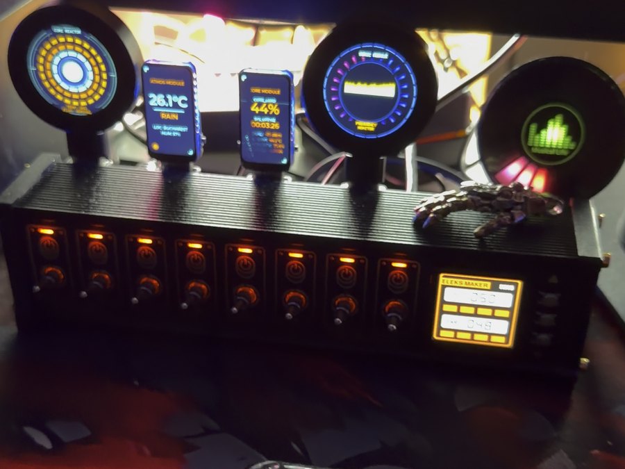 The gauge cluster lit on the desk: round dials, small screens and the button box