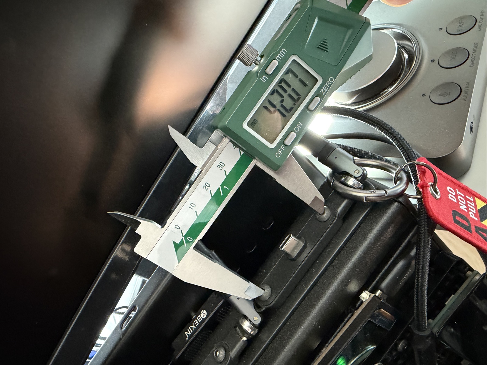 Calipers measuring a part for the center console